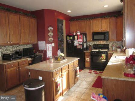 16501 Telescope Lane Dumfries, VA 22026 - Photo 12 of 30 a kitchen with a stove a refrigerator and a sink