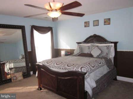 16501 Telescope Lane Dumfries, VA 22026 - Photo 15 of 30 a bedroom with a bed and a chandelier
