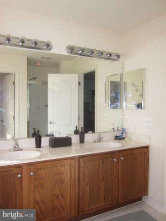 16501 Telescope Lane Dumfries, VA 22026 - Photo 16 of 30 a bathroom with a double vanity sink and a mirror