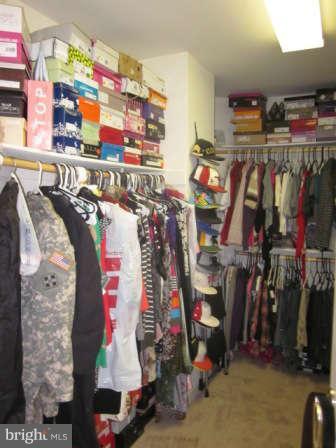 16501 Telescope Lane Dumfries, VA 22026 - Photo 18 of 30 a view of walk in closet with clothes