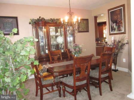 16501 Telescope Lane Dumfries, VA 22026 - Photo 7 of 30 a view of a dining room with furniture and chandelier