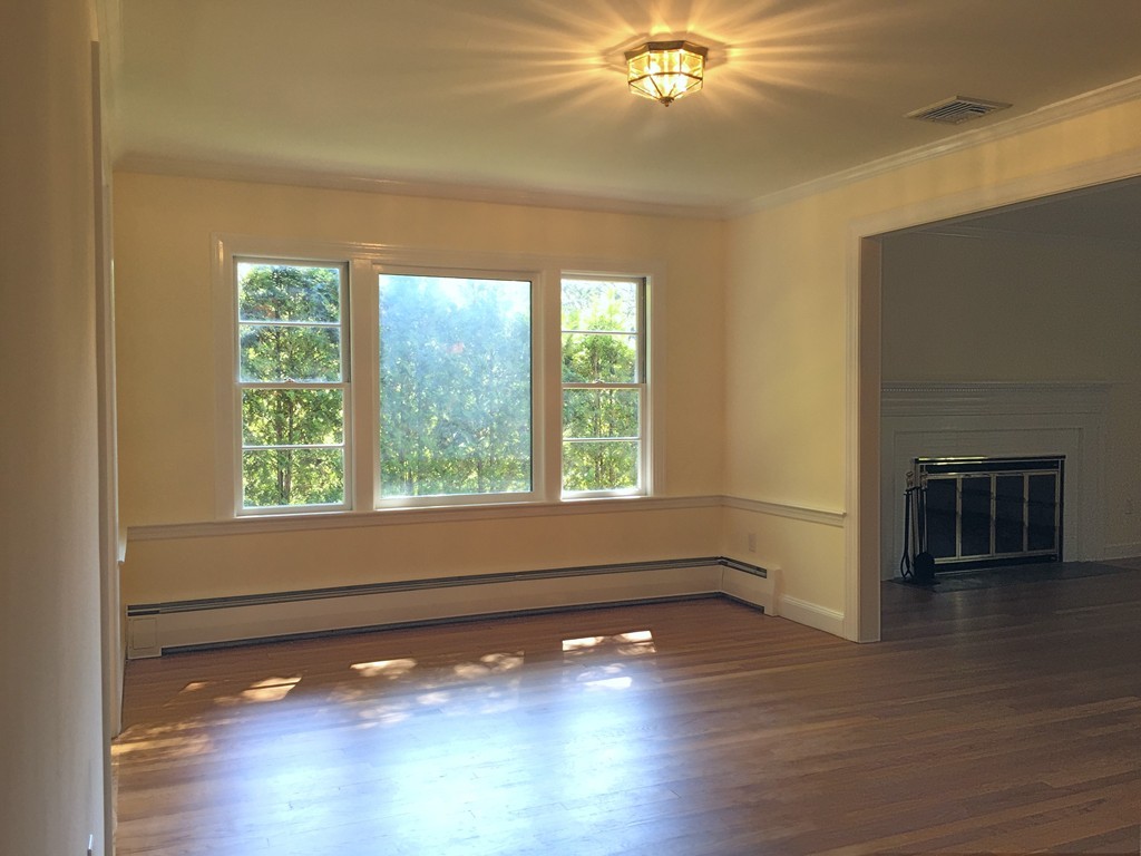 18 Massasoit Road Wellesley, MA 02481 - Photo 5 of 13 a view of an empty room with wooden floor and a window