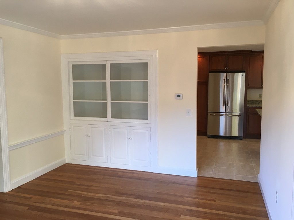 18 Massasoit Road Wellesley, MA 02481 - Photo 6 of 13 a view of empty room with wooden floor and fan