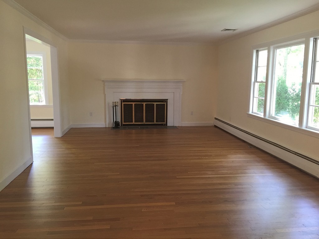 18 Massasoit Road Wellesley, MA 02481 - Photo 7 of 13 wooden floor fireplace and windows in an empty room