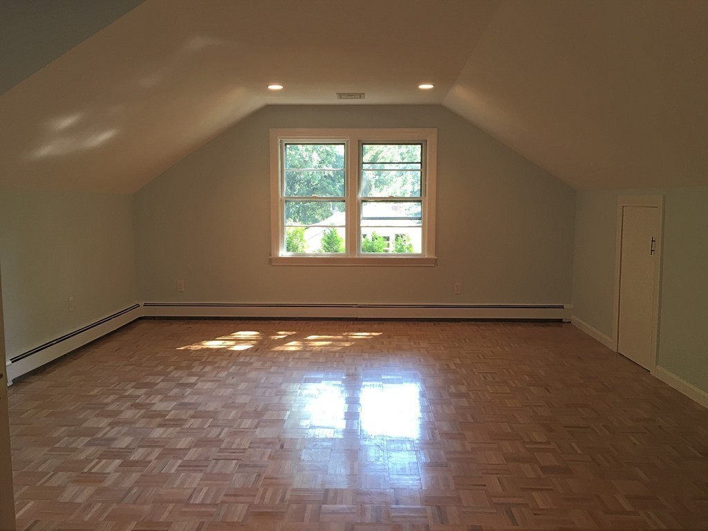 18 Massasoit Road Wellesley, MA 02481 - Photo 9 of 13 a view of empty room with wooden floor and fan