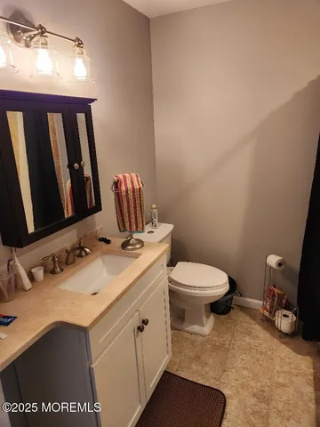 a bathroom with a sink a toilet and mirror