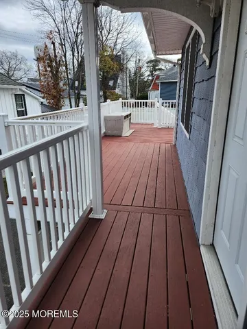 a view of balcony with wooden floor
