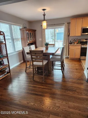 a view of a dining room with furniture window and wooden floor