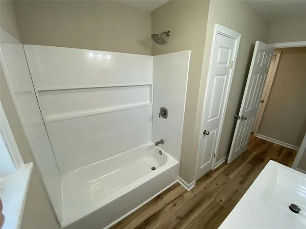 a bathroom with a tub and a shower