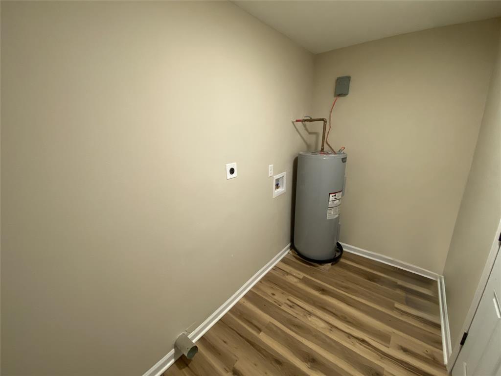 203 Elam Street Mansfield, LA 71052 - Photo 13 of 17 Laundry area with hookup for a washing machine, water heater, and hookup for an electric dryer