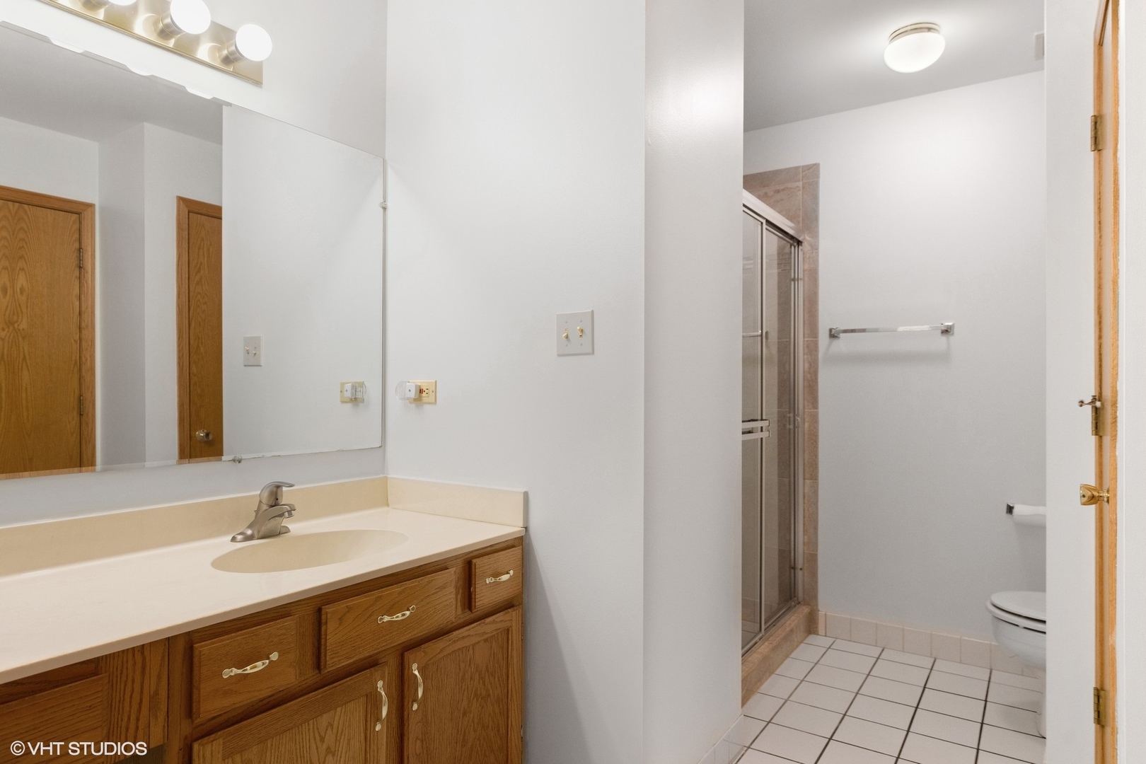 8060 Capra Trail Darien, IL 60561 - Photo 16 of 21 a bathroom with a sink a toilet and shower