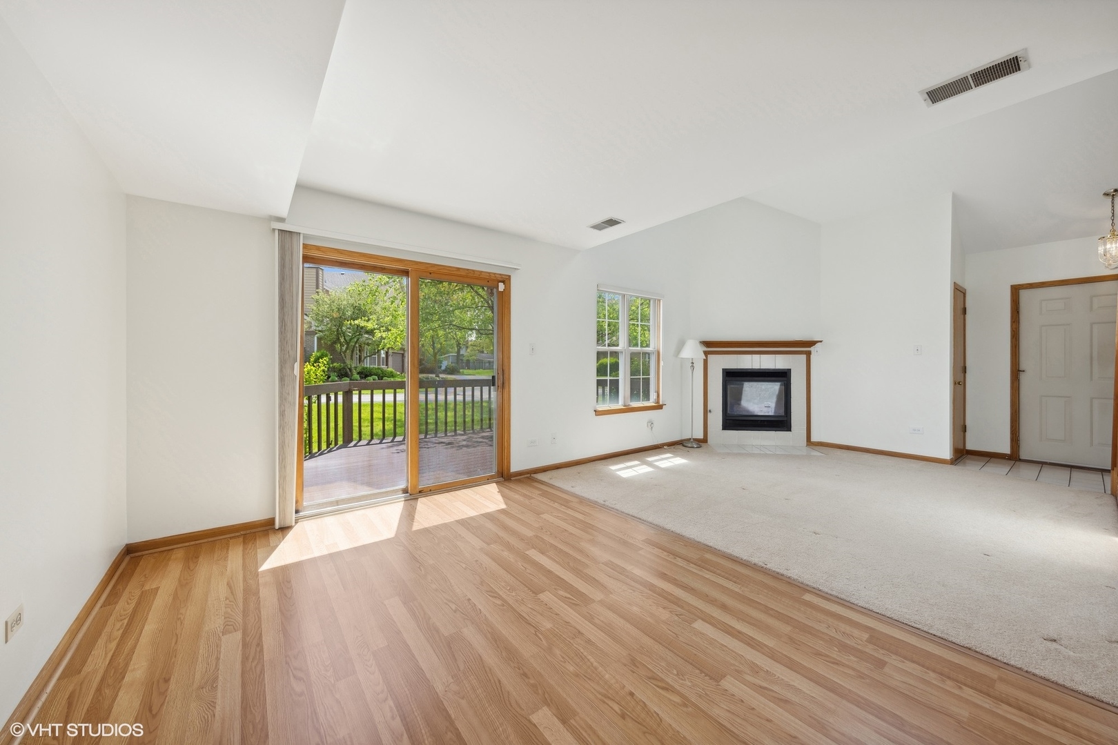 8060 Capra Trail Darien, IL 60561 - Photo 5 of 21 a view of empty room with wooden floor and fireplace