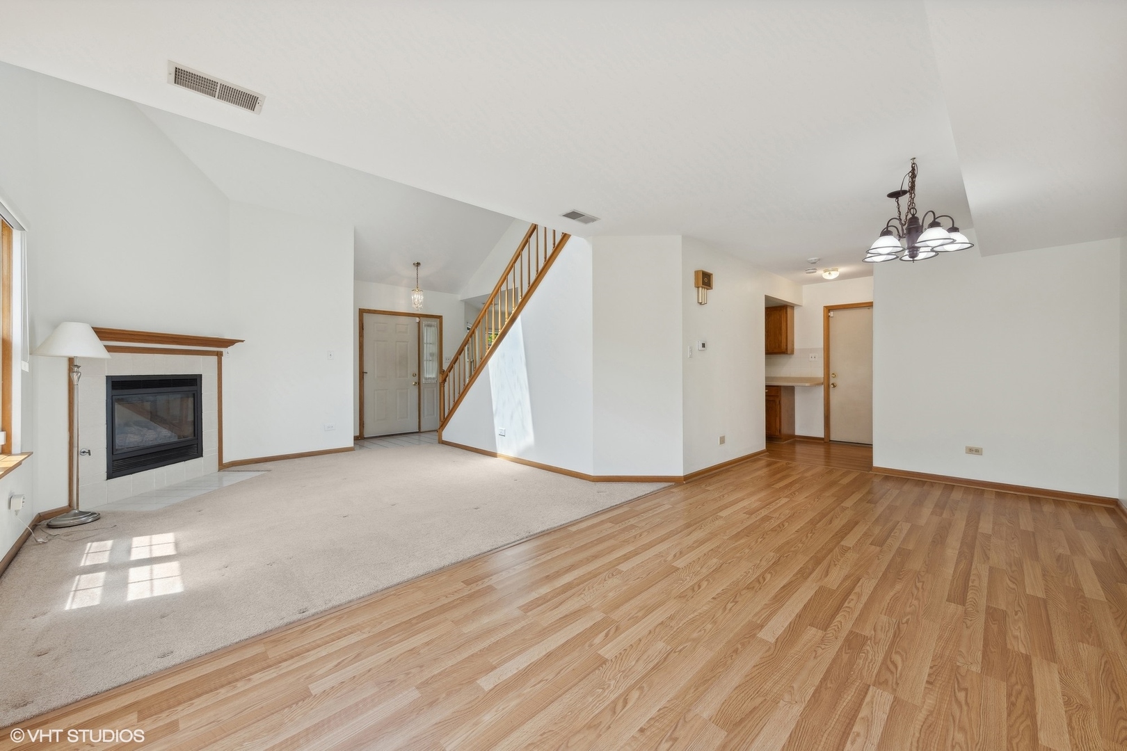 8060 Capra Trail Darien, IL 60561 - Photo 6 of 21 a view of a livingroom with wooden floor and staircase