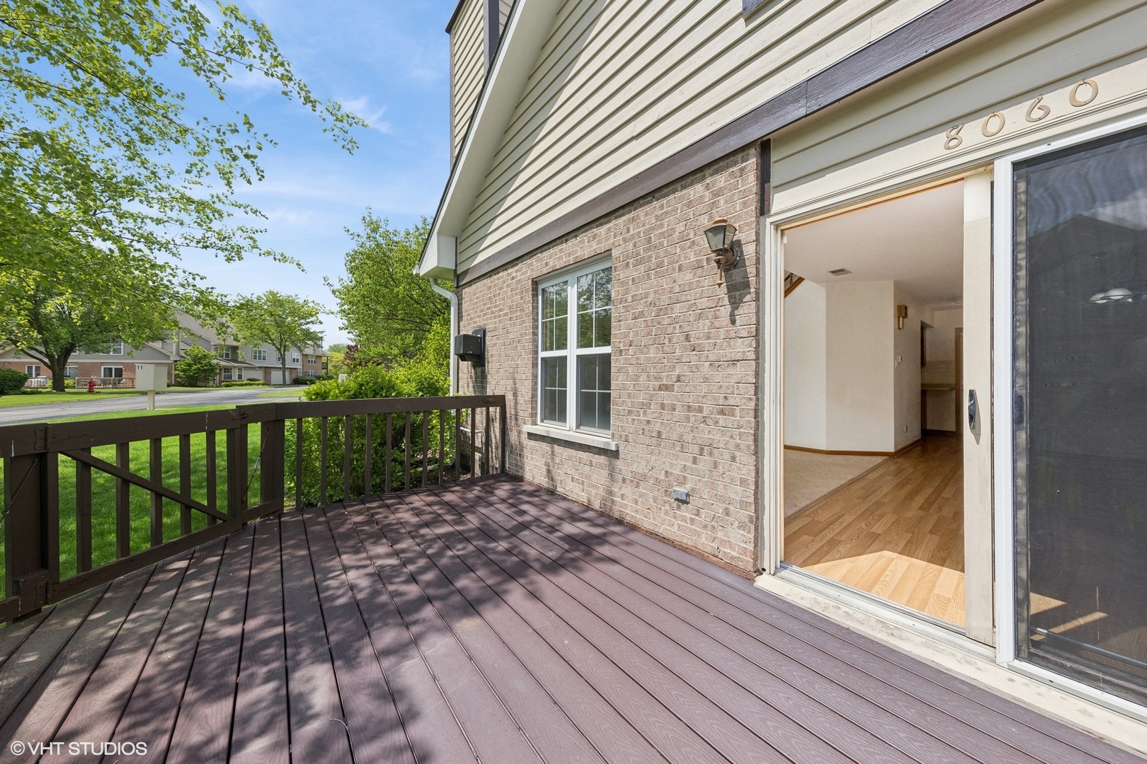 8060 Capra Trail Darien, IL 60561 - Photo 7 of 21 a view of a porch with wooden floor and fence