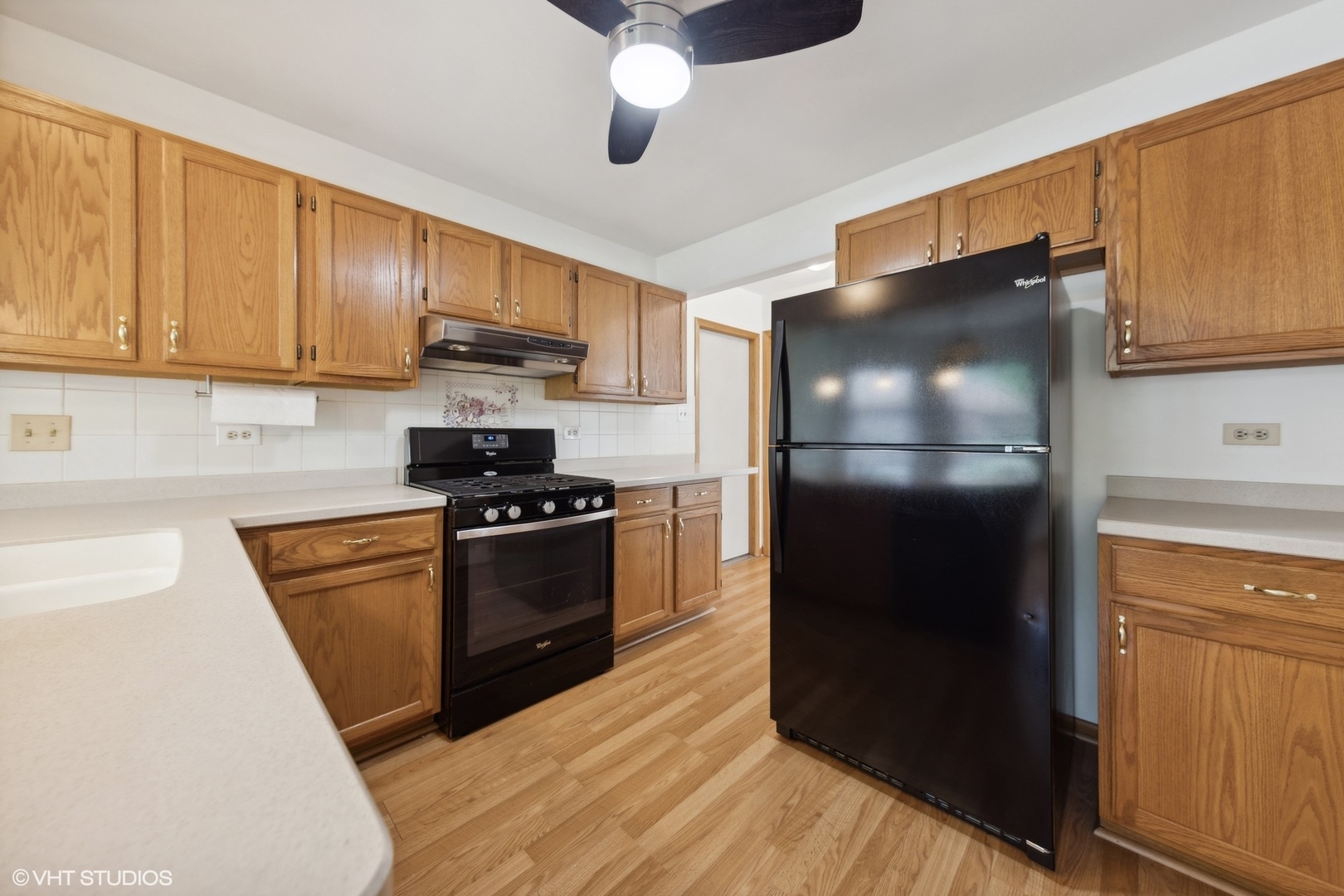 8060 Capra Trail Darien, IL 60561 - Photo 9 of 21 a kitchen with a refrigerator and a stove top oven