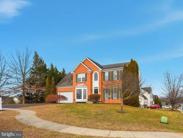 a view of a big house with a big yard and large trees