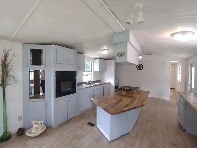 a kitchen with stainless steel appliances granite countertop a sink a stove and a refrigerator