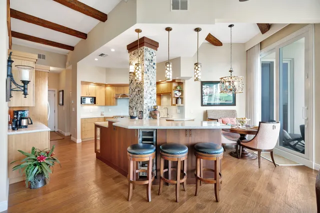 a bedroom with a large bed and a chandelier