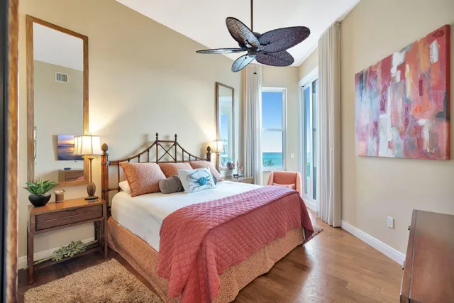 a bedroom with a bed and a painting on the wall