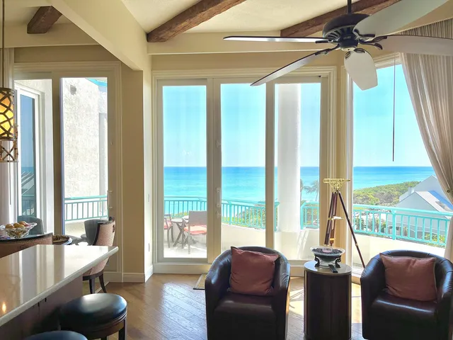 a living room with furniture and a floor to ceiling window