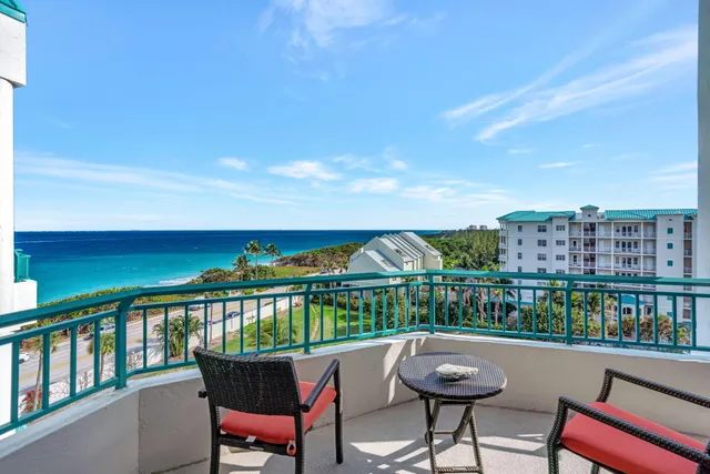 a balcony with table and chairs