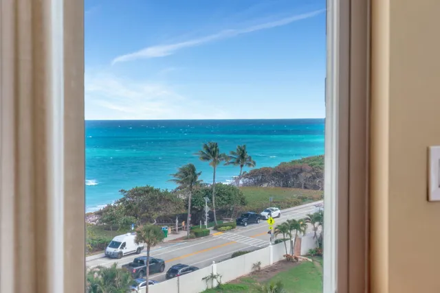 a view of a patio with a table chairs and a backyard