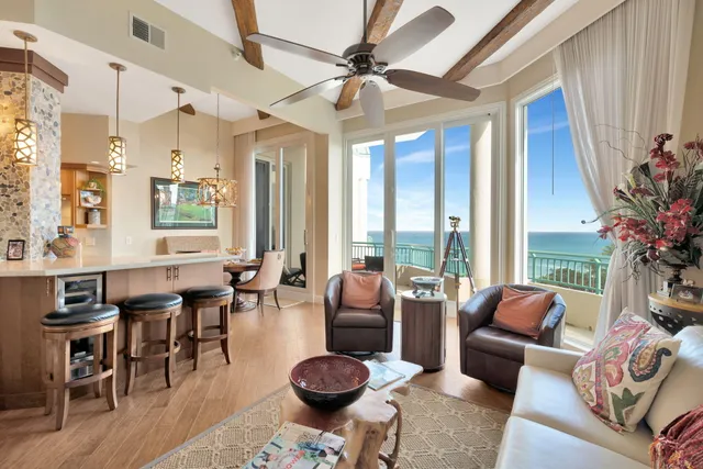 a living room with furniture a table and a large window
