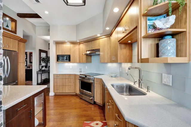 a view of a dining room with furniture chandelier and wooden floor