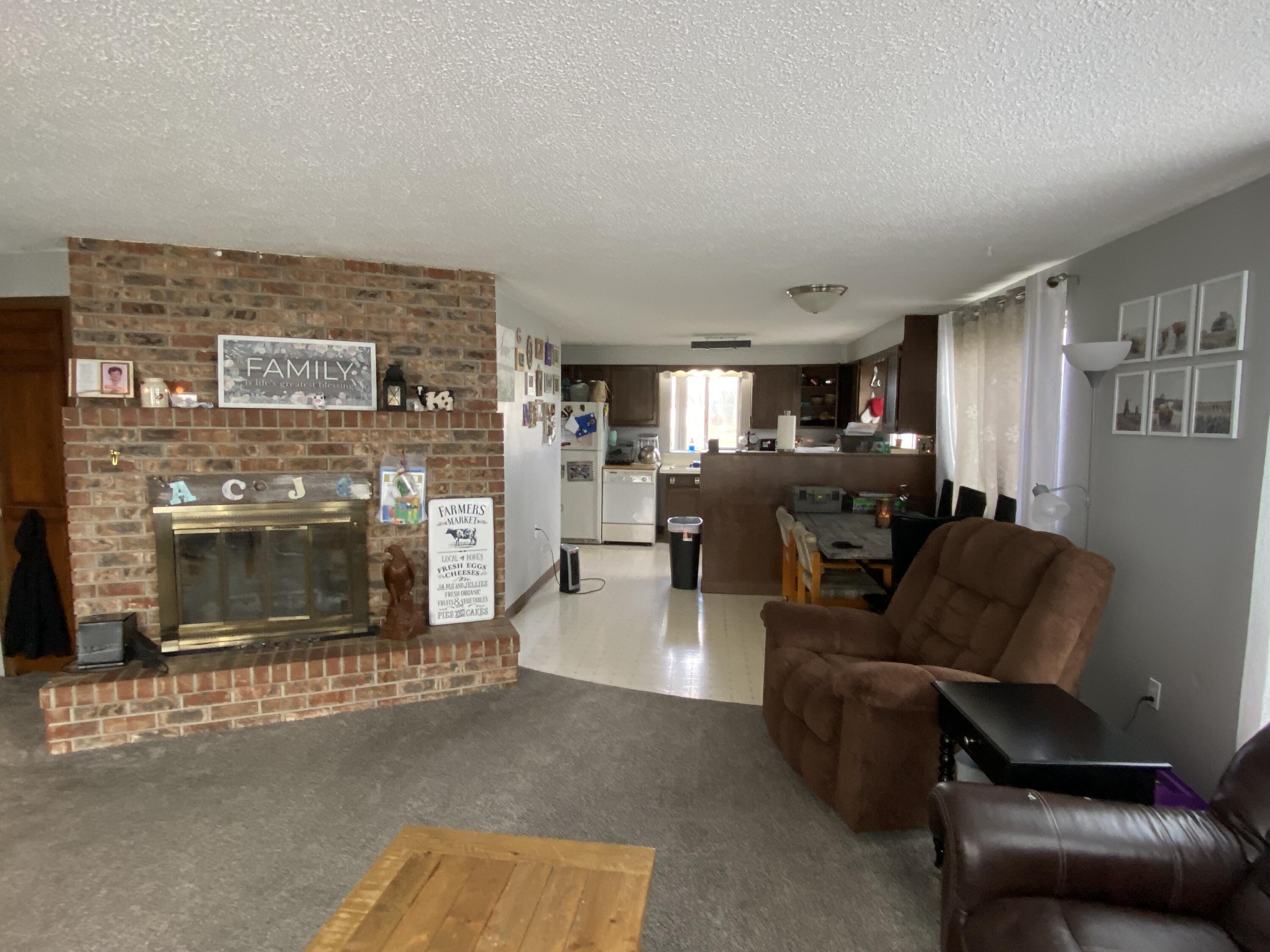 6735 South Prairie Road Tillamook, OR 97141 - Photo 4 of 23 a living room with furniture and a fireplace