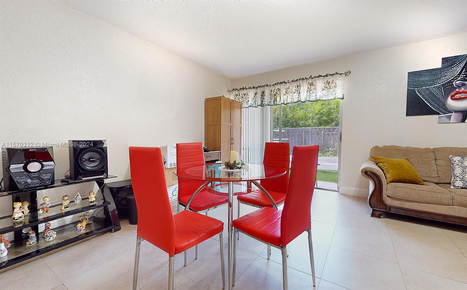 9483 Southwest 76th Street, Unit N3 Miami, FL 33173 - Photo 12 of 27 a living room with furniture a rug and a large window