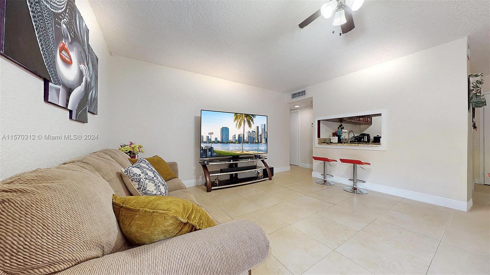 9483 Southwest 76th Street, Unit N3 Miami, FL 33173 - Photo 14 of 27 a living room with furniture and a flat screen tv