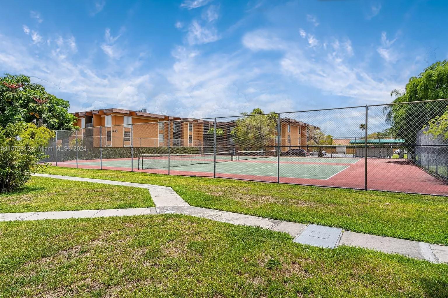 9483 Southwest 76th Street, Unit N3 Miami, FL 33173 - Photo 22 of 27 a view of a house with a big yard and potted plants
