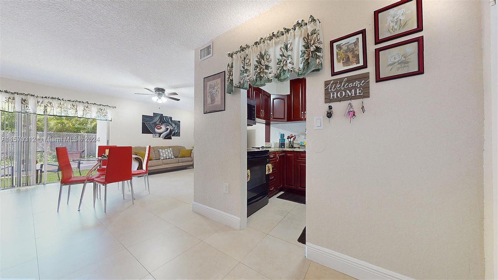 9483 Southwest 76th Street, Unit N3 Miami, FL 33173 - Photo 3 of 27 a view of a livingroom with furniture and workspace