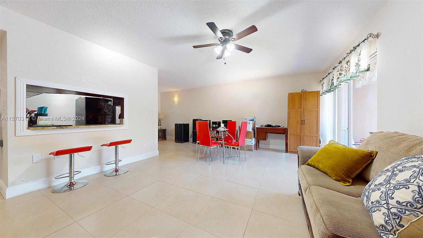 9483 Southwest 76th Street, Unit N3 Miami, FL 33173 - Photo 4 of 27 a living room with furniture and a flat screen tv