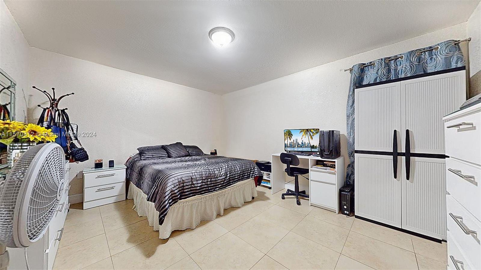 9483 Southwest 76th Street, Unit N3 Miami, FL 33173 - Photo 7 of 27 a bedroom with bed and white cabinets