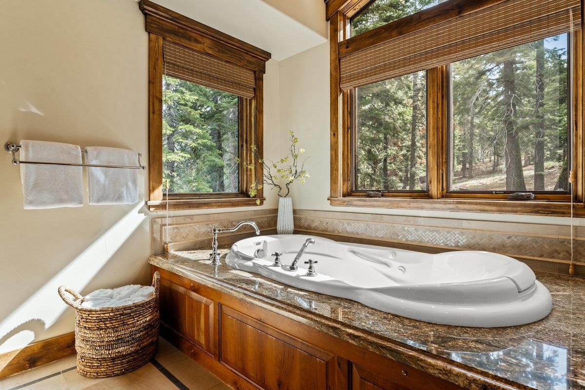 12043 Brookstone Drive Truckee, CA 96161 - Photo 15 of 21 a bathroom with a granite countertop tub and a sink