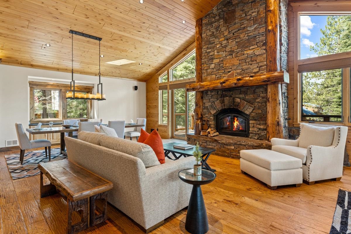 12043 Brookstone Drive Truckee, CA 96161 - Photo 2 of 21 a living room with furniture a fireplace and a floor to ceiling window