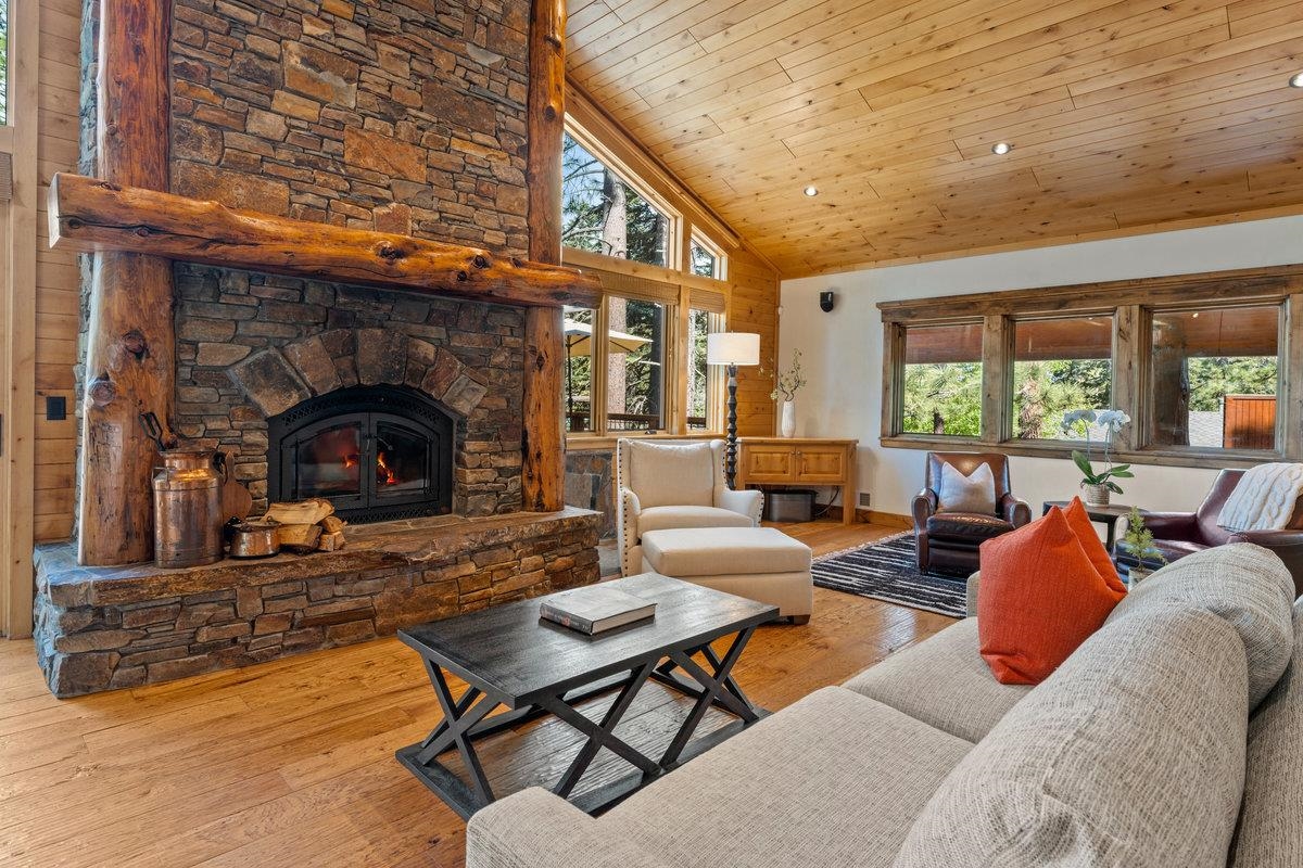 12043 Brookstone Drive Truckee, CA 96161 - Photo 3 of 21 a living room with furniture a fireplace and a table
