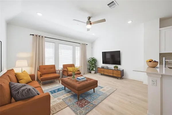 a living room with furniture and a flat screen tv