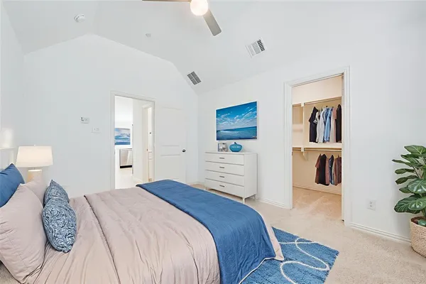 a bedroom with a large bed and a couch