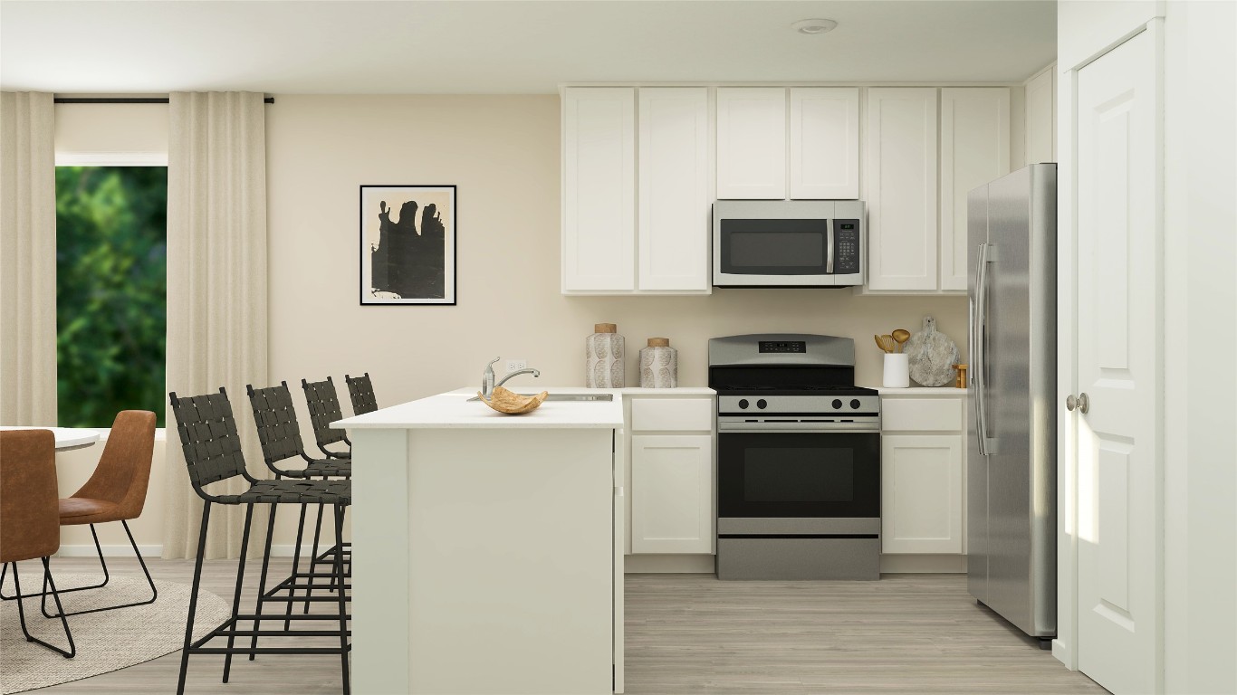 508 Cattle Queen Road Jarrell, TX 76537 - Photo 11 of 27 a kitchen with stainless steel appliances a stove a sink refrigerator and a microwave