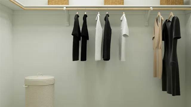 a view of walk in closet with clothes