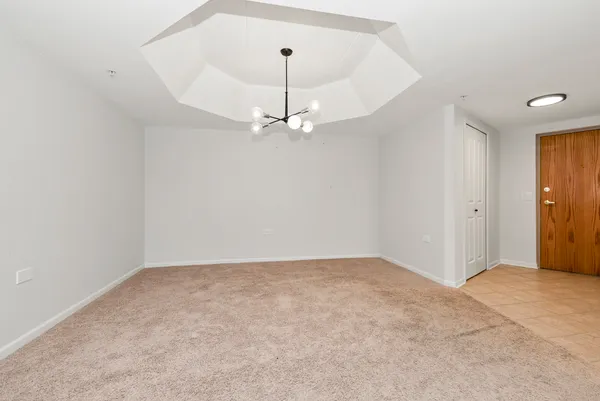 an empty room with a ceiling fan and a window