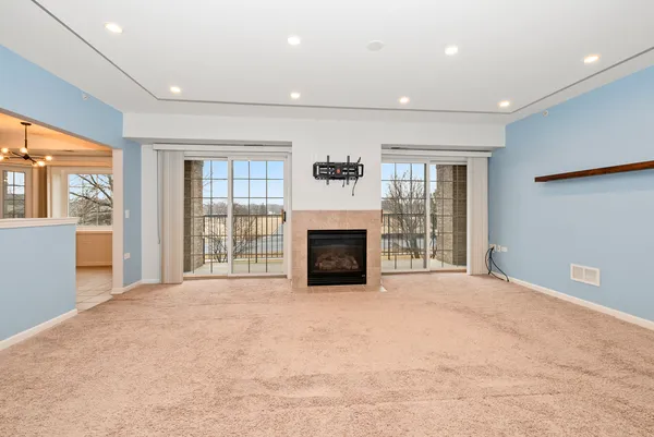 a view of an empty room with a fireplace and a large window