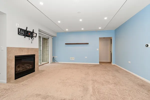 a view of empty room with a fireplace
