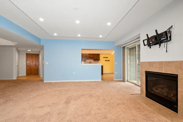 a view of a livingroom with a fireplace and window