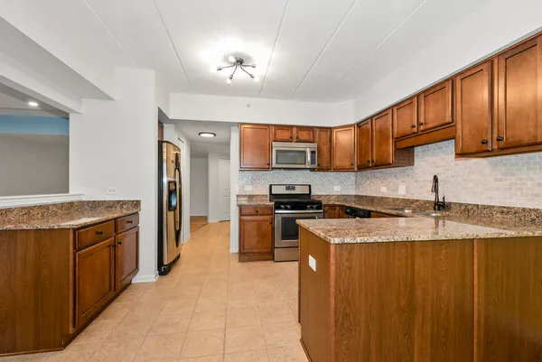 a kitchen with a stove sink and a refrigerator