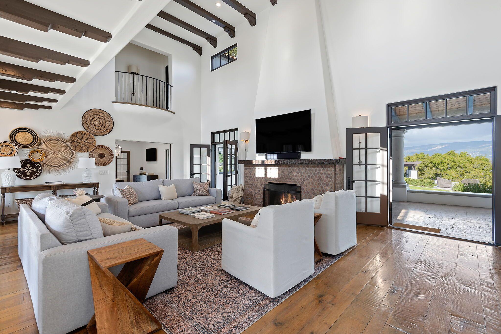 695 Via Hierba Santa Barbara, CA 93110 - Photo 11 of 70 a living room with furniture a flat screen tv and a fireplace