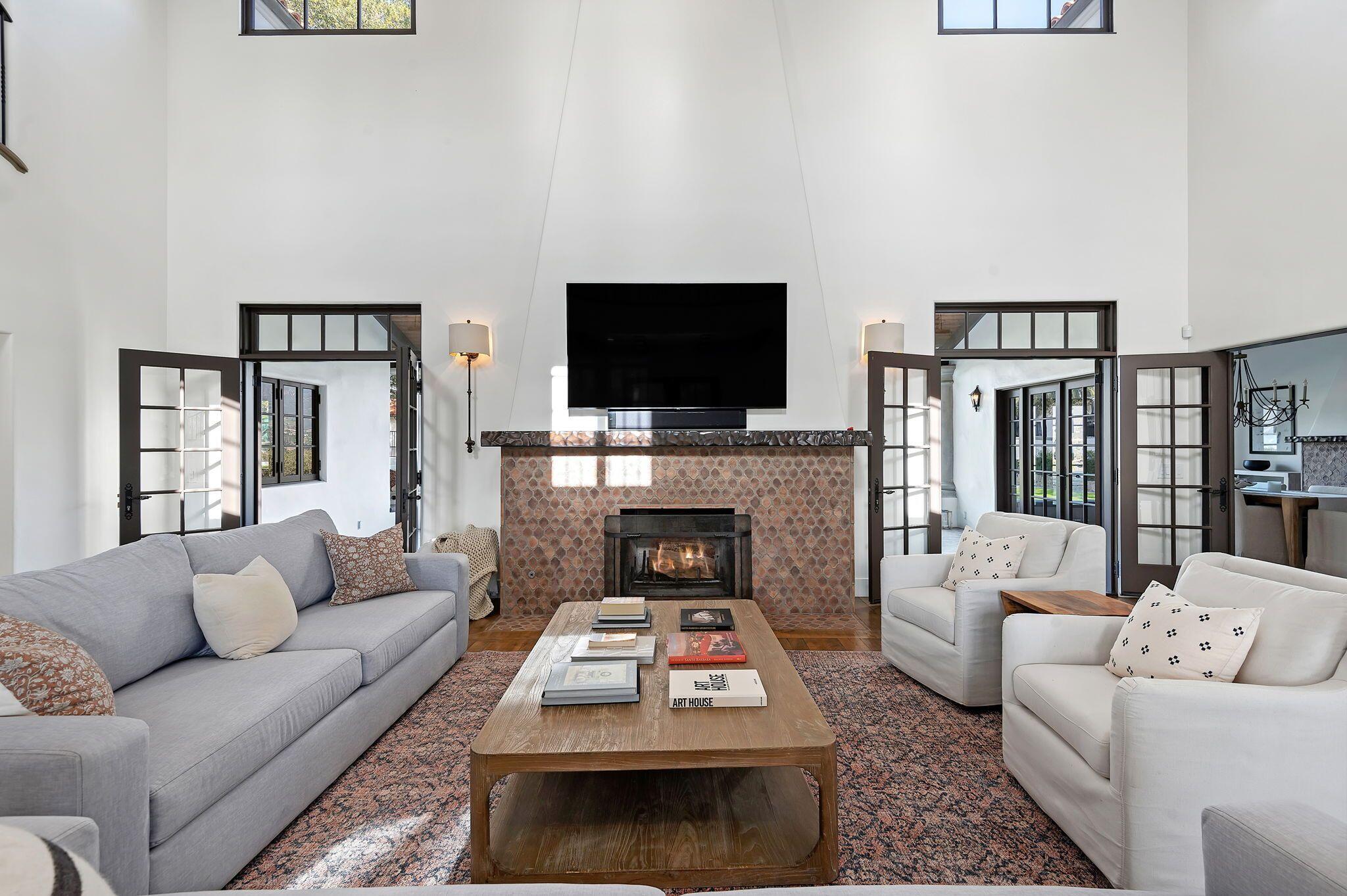 695 Via Hierba Santa Barbara, CA 93110 - Photo 12 of 70 a living room with furniture a flat screen tv and a fireplace