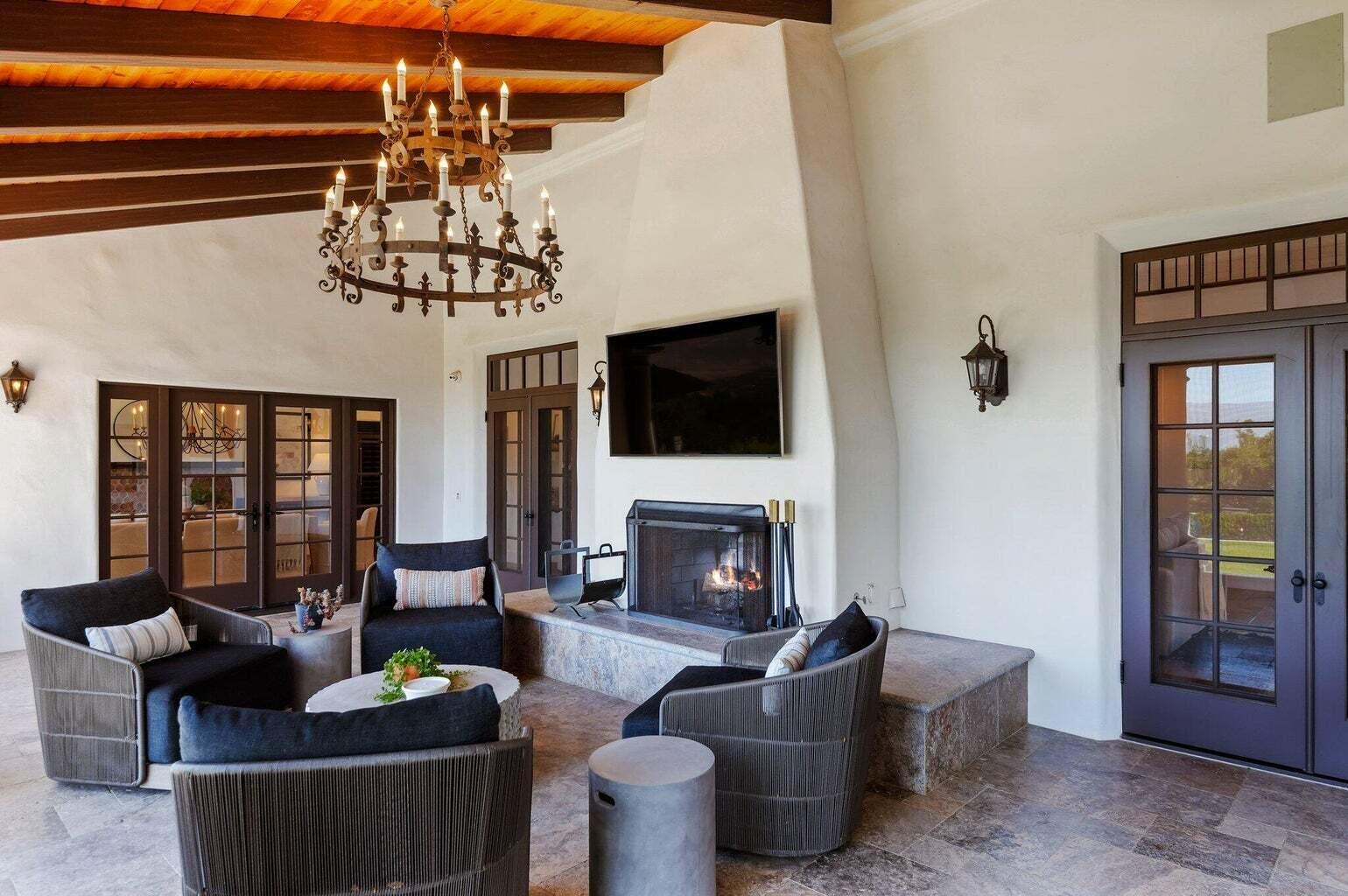 695 Via Hierba Santa Barbara, CA 93110 - Photo 15 of 70 a living room with furniture a fireplace and a chandelier
